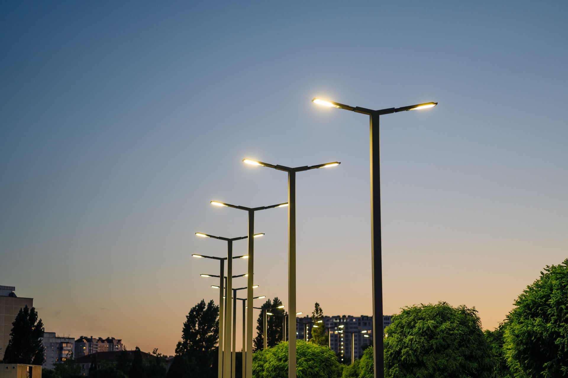 A modern street LED lighting pole. Urban electro-energy technologies. A row of street lights against the night sky